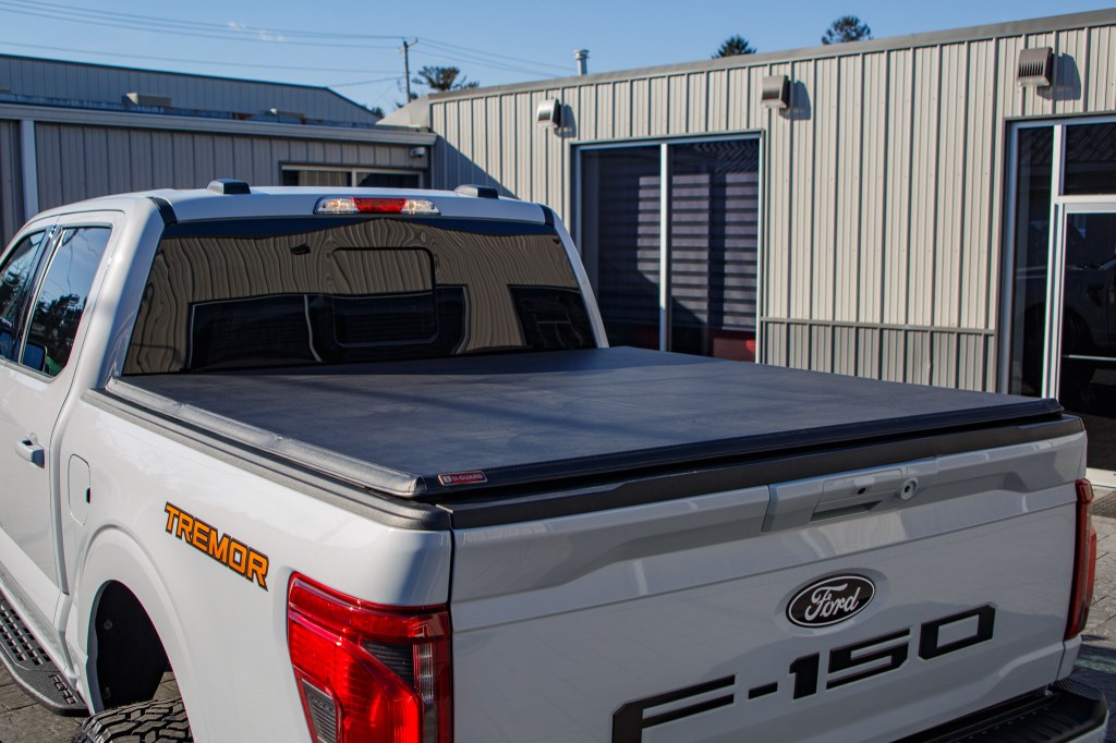 A 2025 Ford F-150 Tremor with a soft tri-fold bed cover, a 6" Rough Country lift kit, 22x12 Fuel Rebar wheels, and 35" Fury Country Hunter R/T tires.